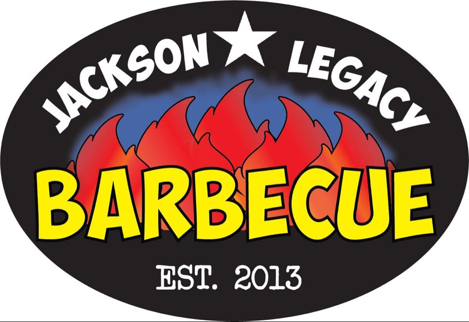 A black horizontally oriented oval with the words Jackson Legacy in white font separated by a large five pointed white star arcing over five red flames with a blue aura. The word Barbecue is in yellow capitalized letters over the bottom of the flames and EST. 2013 is in a white type writer style font below it on the black oval.