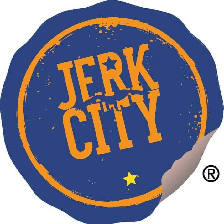 A navy blue circle with a gold circular outline just inside the edge. The words Jerk City are stacked on top of each other, centered on the blue circle with the circle in the R shaped liked a five pointed star. A yellow five pointed star is centered below City inside the gold circular outline. The whole image is tilted at a 15 degree angle to the left of center.